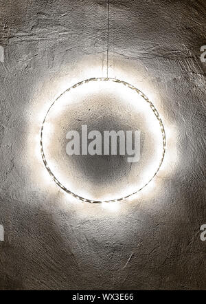 Christmas decoration wall hanging of metal ring with chain of lights Stock Photo