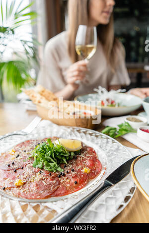 Closeup carpaccio, meat plate in the restaurant. Variety of dishes on the table. Italian cuisine Stock Photo