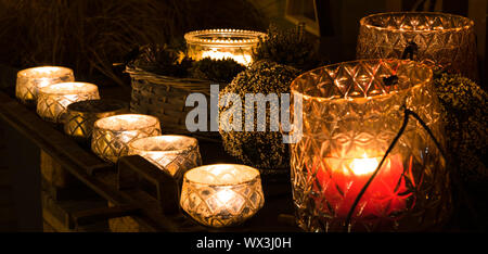 decorative and festive Christmas holiday arrangement with glasses and candles and assorted decorativ Stock Photo