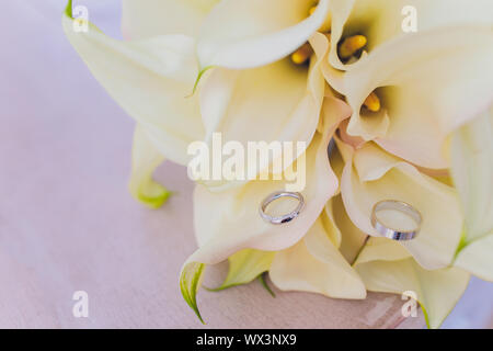 Bouquets of flowers on the floor in front of a flower shop with lilies, sunflowers, carnations, statices, and more Stock Photo