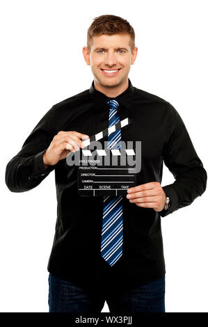 Young guy holding clapboard. Its showtime Stock Photo