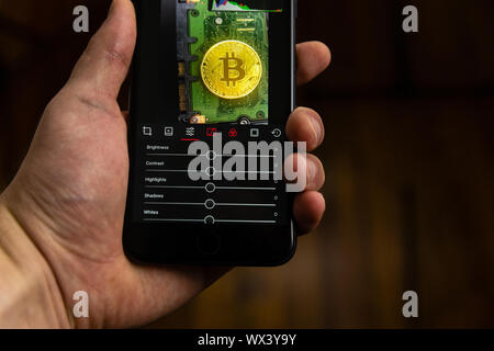 Editing a photo with a smartphone app Stock Photo