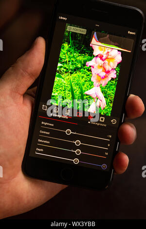 Editing a photo with a smartphone app Stock Photo