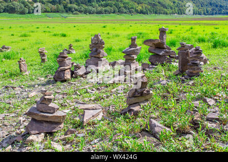 Piles of natural stones in dry german river bed Stock Photo