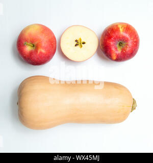 Yellow pumpkin and three apples on a white background. Stock Photo