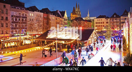 People on the illuminated ice rink on the Heumarkt, Cologne, North Rhine-Westphalia, Germany, Europe Stock Photo
