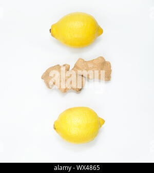 Fresh lemons and ginger root on a light background. Stock Photo