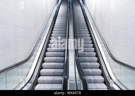 empty long escalator in a train station Stock Photo