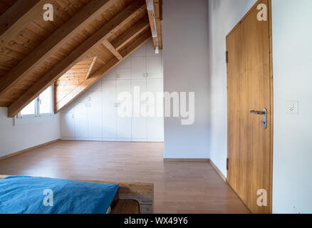 bright light modern simple master bedroom with wooden parquet floors and designer closet and traditi Stock Photo