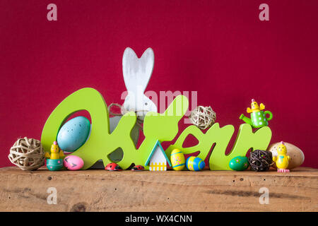 Word Easter in german language with easter bunny eggs and chicks Stock Photo