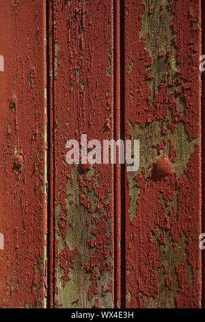 Paint peeling from an old french wooden door. Stock Photo