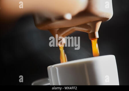 Macro photo of making fresh espresso coffee in a coffee machine. Breakfast Stock Photo