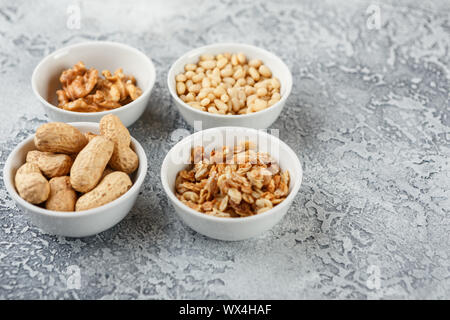 Different nuts on gray background Stock Photo