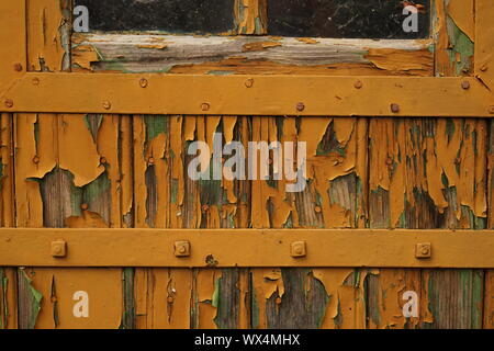 Peeling paint from an old wooden door Stock Photo