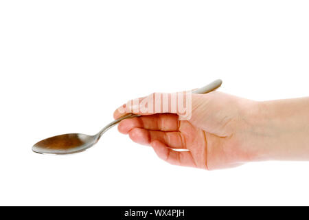 A spoon being held by a female hand.  Isolated on white with clipping path. Stock Photo
