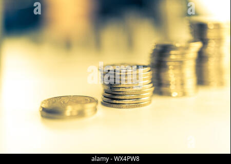 Stack of coins macro. Rows of coins for finance and banking concept. Economy trends background for business idea. Stock Photo