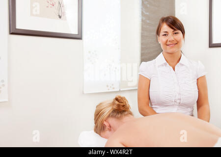 Portrait of a professional acupuncturist posing with patient ready for treatment Stock Photo