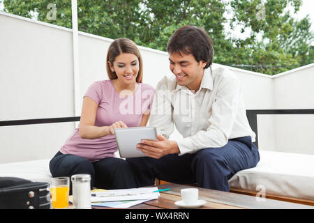 Indian male architect having discussion with female client over a digital tablet Stock Photo