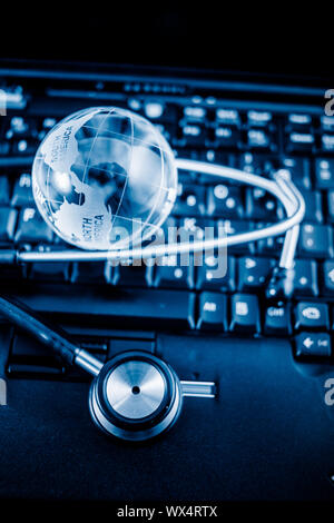 Glass globe and stethoscope Stock Photo