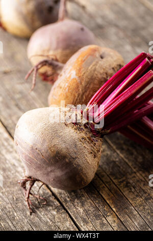 Tasty raw beetroot. Healthy vegetable on old wooden table. Stock Photo