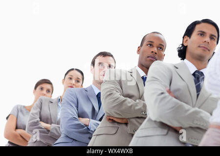 Low-angle shot of a business team crossing their arms in a single line against white background Stock Photo