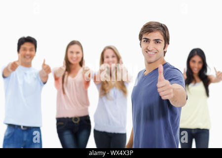 People smiling and approving with one of them in foreground against white background Stock Photo