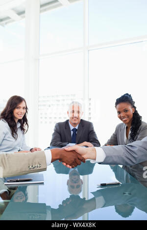 Friendly handshake between two colleagues during a meeting Stock Photo