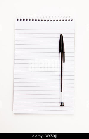 Notepad  with black pen sheet  against a white background Stock Photo