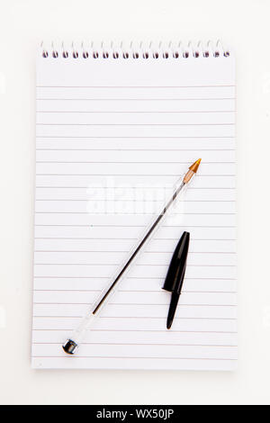 Notepad  with black pen sheet  against a white background Stock Photo