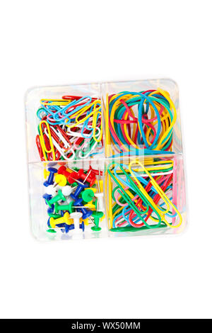 Box of multicolored of pushpins paperclips and elastics against a white background Stock Photo