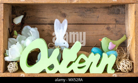 word easter in german language with decoration in a wooden box Stock Photo