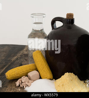 moonshine demi jug and ingredients on rustic wooden table Stock Photo