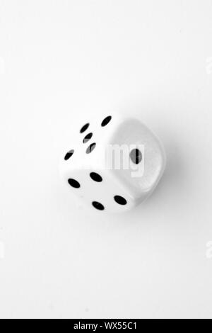 Black and white dice in motion against a white background Stock Photo