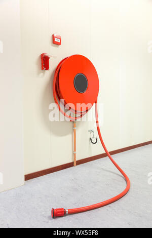 Fire hose in building for fire fighting Stock Photo