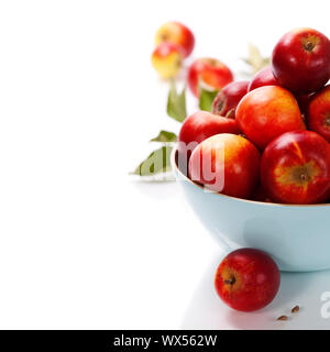 Fresh apples in a bowl over white. With copyspace Stock Photo