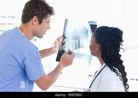 Happy doctors looking at a of X-ray Stock Photo