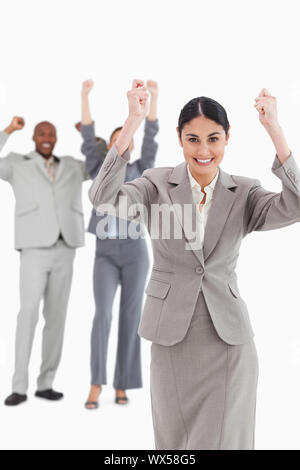 Triumphant businessman with cheering team behind him Stock Photo - Alamy
