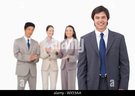 Businessman getting applause from colleagues against a white background Stock Photo