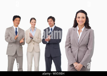 Businesswoman getting applause by colleagues against a white background Stock Photo