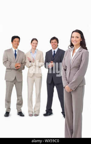 Businesswoman getting applause by her colleagues against a white background Stock Photo