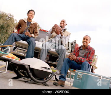 Low angle view of three friends picnicking. Stock Photo