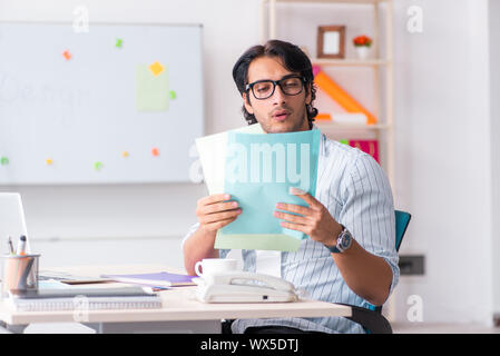 Young handsome male designer working in the office Stock Photo