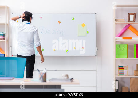 Young handsome male designer working in the office Stock Photo