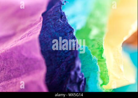 Multi-colored crumpled real vivid paper sheets texture background. Close up. Shallow depth of field. Stock Photo