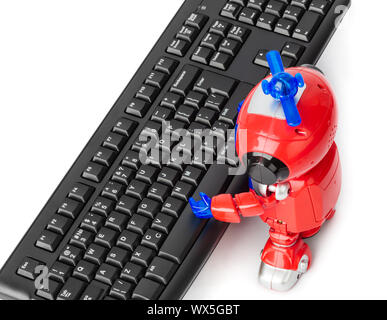 Toy robot and computer Stock Photo