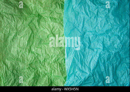 Multi-colored crumpled real vivid paper sheets texture background. Green, cyan. Stock Photo