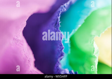 Multi-colored crumpled real vivid paper sheets texture background. Close up. Shallow depth of field. Stock Photo