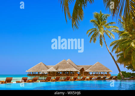 Pool and cafe on Maldives beach Stock Photo