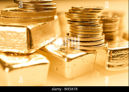 Gold bullions and stack of coins. Background for finance banking concept. Trade in precious metals. Stock Photo