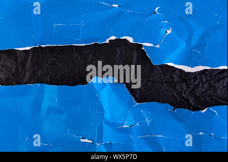 Multi-colored crumpled real vivid paper sheets texture background. Blue, black. Stock Photo